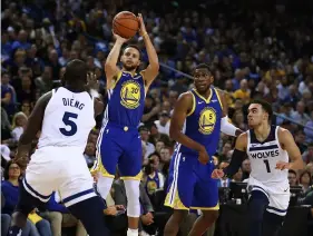  ?? AP PhoTo/BeN MArgoT ?? Golden State Warriors’ Stephen Curry (30) shoots over Minnesota Timberwolv­es’ Gorgui Dieng (5) during the second half of an NBA basketball game on Friday in Oakland, Calif.