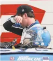  ?? Brynn Anderson / Associated Press ?? Chase Briscoe, who with his wife suffered a family loss, wipes away tears after winning a NASCAR Xfinity race.