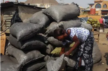  ??  ?? Mrs. Goza in her Charcoal business place