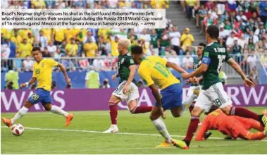  ??  ?? Brazil’s Neymar (right) miscues his shot as the ball found Roberto Firmino (left) who shoots and scores their second goal during the Russia 2018 World Cup round of 16 match against Mexico at the Samara Arena in Samara yesterday. –