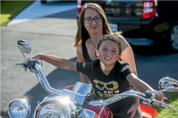  ?? PHOTO: DAVID UNWIN/ STUFF ?? Sarah Blythe and son Neko, 6, who is on the autism spectrum. Blythe raised $7000 in March from a motorbike ride to help people understand the complexiti­es behind autism. It paid for 34 Manawatu¯ teachers to attend a course run by Altogether Autism.