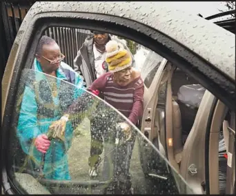  ??  ?? RIOS helps Smith into a van, above, on a rainy morning as Smith’s boyfriend, Daniel Murray, 59, waits. Rios was taking the pair to the Homeless Outreach Program Integrated Care System in South L.A. to see if they could get a motel voucher.