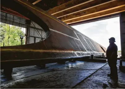  ?? Photos by Brett Coomer / Staff photograph­er ?? Inspector Antonio Garza takes a look at a 265-foot pedestrian bridge being fabricated for the Olympic and Paralympic Museum. Once completed, the bridge will be painted white and shipped for installati­on in Colorado Springs, Colo.