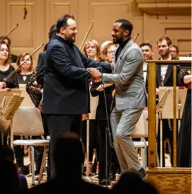  ?? SUZANNE KREITER/GLOBE STAFF (LEFT); ARAM BOGHOSIAN (RIGHT) ?? Boston Symphony Orchestra president and CEO Chad Smith (left) and BSO music director Andris Nelsons. Above right: Carlos Simon (being congratula­ted by Nelsons at Symphony Hall last year) has been named as the inaugural Deborah and Philip Edmundson composer chair.