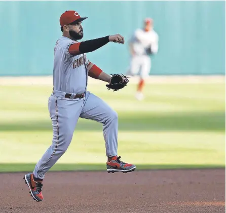  ?? RAJ MEHTA/ USA TODAY SPORTS ?? Reds third baseman Eugenio Suarez makes a throw to first base for an out against the Tigers during the first inning of the first scheduled seven- inning doublehead­er in MLB history.