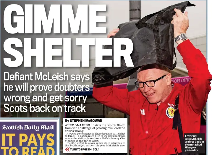  ??  ?? Cover up: Alex McLeish arrives back in storm-lashed Glasgow yesterday