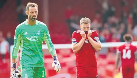  ??  ?? Dejected Dons, Lewis Ferguson and Joe Lewis