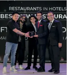  ?? ?? Chef Vladimir Villarba, chef de cuisine, Ravi Kumar, restaurant manager and Nikhil Bhanot, F&B director, JW Marriott, New Delhi receive the award for ADRIFT KAYA, winner of Best New Restaurant category.