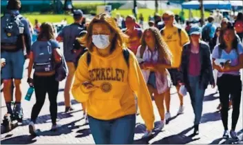  ?? FILE PHOTO: GABRIELLE LURIE — POLARIS ?? Monica G. wears a mask while walking through the UC Berkeley campus. The 10-campus system has faced significan­t revenue losses during the pandemic, leading UC to seek increased aid in the 2021-22 state budget to make up for most of it.