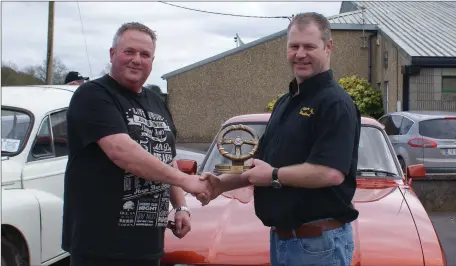  ??  ?? Michael Hurley receiving the prize for best car from Mr. Pat O’Riordan sponsor at the Broomhill Vintage club run.