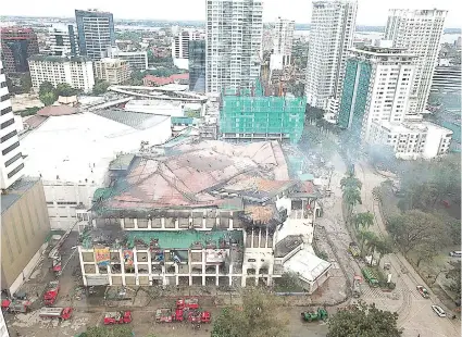  ?? / ALAN CUIZON ?? AERIAL VIEW SA METRO AYALA. Ang nagusbat nga atop sa Metro Ayala human naigo sa dakong sunog niadtong Biyernes sa gabii apan gideklarar sa mga bombero nga ‘under control’ kagahapon ug gipaabot nga madeklarar karon nga ‘fire out..