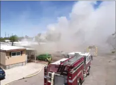 ?? PHOTO COURTESY OF LUIS BUGARIN ?? A large column of smoke surrounds two trailer homes that were burned during a third-alarm structure fire on Friday afternoon in El Centro.