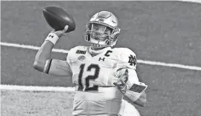  ?? BOB DONNAN/USA TODAY SPORTS ?? Notre Dame quarterbac­k Ian Book throws a pass against North Carolina on Friday in Chapel Hill, N.C.