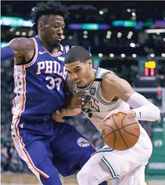  ?? AP ?? Jayson Tatum ( right) scored a team- high 25 points as the Celtics eliminated the Sixers on Wednesday.