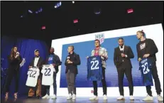  ?? Associated Press ?? United States soccer players (from left to right) DeAndre Yedlin, Shaq Moore, Aaron Long and Walker Zimmerman hold up jerseys, Wednesday, in New York, after being announced as defenders on the U.S. men’s national soccer roster for the upcoming World Cup in Qatar.