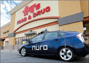  ?? AP/ROSS D. FRANKLIN ?? A self-driving Nuro vehicle parked outside a Fry’s supermarke­t, which is owned by Kroger, is part of a pilot program for grocery deliveries in Scottsdale, Ariz.