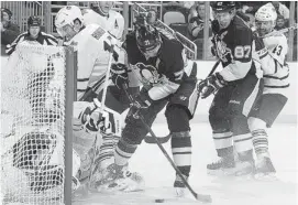  ?? JOE SARGENT/NHLI VIA GETTY IMAGES ?? Penguins forward Evgeni Malkin knocks a loose puck past Leafs goalie Jonathan Bernier Wednesday at Consol Energy Center in Pittsburgh. The Penguins won 6-5 in a shootout.