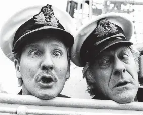  ?? Ian Showell/Keystone/Getty Images ?? > Leslie Phillips (left) and Jon Pertwee promoting their BBC radio show ‘The Navy Lark’