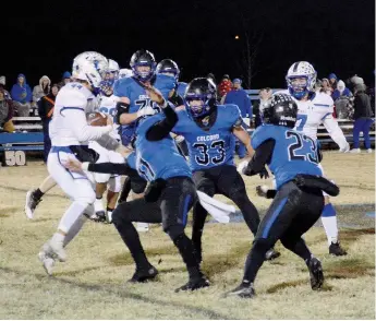  ?? Graham Thomas/Herald-Leader ?? Colcord (Okla.) football players, Gabe Winfield, Cooper Mott and Jesse Martinez swarm to tackle a Haskell ball carrier during the Hornets’ 47-0 win Friday, Nov. 11.