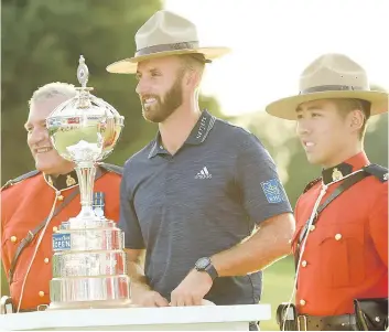  ?? NATHAN DENETTE/ THE CANADIAN PRESS ?? American Dustin Johnson dons the hat of one of the Mounties on hand as he was presented the Canadian Open championsh­ip trophy at Glen Abbey in Oakville, Ont., Sunday.