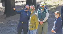  ?? CRAIG KOHLRUSS/ASSOCIATED PRESS ?? Gov. Gavin Newsom meets with local fire officials while touring an area burned by last year’s Creek Fire near Shaver Lake in Fresno County, Calif., on Thursday.