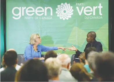  ?? COLE BURSTON / THE CANADIAN PRESS FILES ?? Green Party of Canada leader Elizabeth May, left, speaks with Annamie Paul last September. Paul is solidifyin­g her
spot as a front-runner in the race to succeed May at the party’s helm, raising almost $121,000 so far.