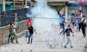  ??  ?? Protesters pelt stones at security personnel in Srinagar on Friday. IANS