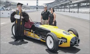  ?? Michael Conroy / Associated Press ?? Jacob Foxworthy, left, poses with his parents Ted and Cindy Foxworthy around a vintage race car after he received his Speedway High School diploma.
