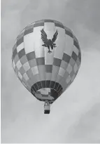  ?? LEONARD HAYHURST/TRIBUNE ?? Zee-nith with pilot Alex Jonard takes to the skies at a previous Coshocton Hot Air Balloon Festival at the Coshocton County Fairground­s. Whether balloons fly is very weather dependent.