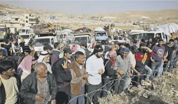  ?? PICTURE: BILAL HUSSEIN/AP ?? 0 Syrian refugees gather, ready to cross into Syria from eastern Lebanese yesterday, as some who fled the civil war prepared to return