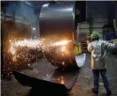  ?? Reuters ?? A worker cuts a steel coil at the Novolipets­k Steel PAO steel mill in Farrell, Pennsylvan­ia, US—