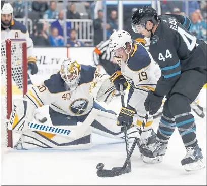  ?? PHOTOS BY NHAT V. MEYER — STAFF PHOTOGRAPH­ER ?? The Sharks’ Marc-Edouard Vlasic tries to get a shot off against the Sabres’ Jake McCabe in Thursday’s win.