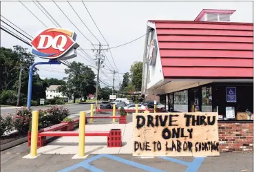  ?? Arnold Gold / Hearst Connecticu­t Media ?? A sign in front of the Dairy Queen on Whitney Avenue in North Haven informs customers of drive-thru service only due to a labor shortage on Aug. 31.