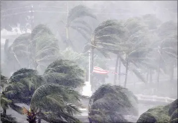  ?? ASSOCIATED PRESS ?? AN AMERICAN FLAG IS TORN as Hurricane Irma passes through Naples, Fla., Sunday.