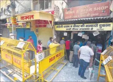  ?? SONU MEHTA/HT PHOTO ?? People with e-tokens buy alcohol from a store in Jheel Chowk on Saturday.