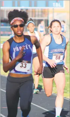  ?? STAFF PHOTO BY AJ MASON ?? Lackey sophomore Dominique Jeffery, left, took first in the 100-meter dash and also placed second in the 200 as Leonardtow­n’s Leya Essex trails from behind in the event in Tuesday’s quad-meet at Lackey.