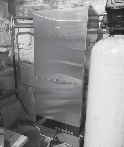  ?? STEVE MAXWELL ?? An automatic water distiller like this can sit in the basement or anywhere else in your house, quietly filling an on-board reservoir as they operate. A small pump distribute­s distilled water to a dedicated tap installed at any sink, or you can draw water directly from the unit.