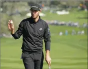  ?? ASSOCIATED PRESS ?? DUSTIN JOHNSON HOLDS up his ball after making a birdie on the sixth green of the Pebble Beach Golf Links during the third round of the AT&T Pebble Beach National Pro-Am golf tournament Saturday in Pebble Beach, Calif.