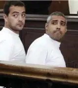  ?? HEBA ELKHOLY/THE ASSOCIATED PRESS ?? In this March 31, 2014 file photo, Al Jazeera English producer Baher Mohamed, left, and CanadianEg­yptian acting Cairo bureau chief Mohamed Fahmy appear in court along with several other defendants during their trial on terror charges, in Cairo.