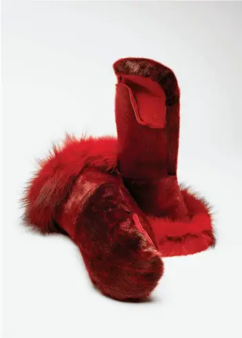  ?? COURTESY THE ROOMS PHOTO NED PRATT PHOTOGRAPH­Y ?? Maria Merkuratsu­k
(b. 1958 Nain)
—
My Father’s Pattern
2015
Red sealskin, cowhide, fox tail, pile lining, cotton, sinew and thread
45.7 × 20.3 × 10.2 cm