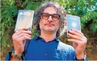  ??  ?? Lebanese film director Ziad Doueiri, holds up his Lebanese and French Passports as he speaks to journalist­s after being released by a military court, in Beirut, Lebanon yesterday. — AP photos