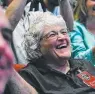  ??  ?? Annette Tombaugh Sitze, daughter of Pluto discoverer Clyde Tombaugh, watches images of Pluto. Picture: AFP