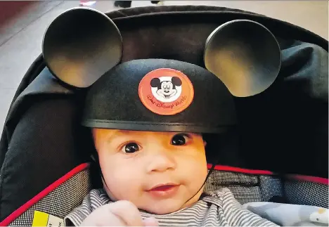  ?? AMY ORNDORFF/WASHINGTON POST ?? Five-month-old Simon Rampersad was rewarded with mouse ears in Orlando, Fla., after his first flight.