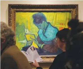  ?? ANDY MORRISON/DETROIT NEWS VIA AP ?? Visitors file past the Van Gogh painting “Une Liseuse De Romans,” also known as “The Novel Reader,” during the Van Gogh in America exhibit at the Detroit Institute of Arts on Jan. 11 in Detroit.