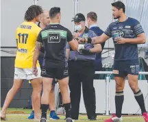  ??  ?? Match referee Henry Perenara (centre) conducts the coin toss with Titans’ Kevin Proctor (left) and Cowboy Jordan Mclean.