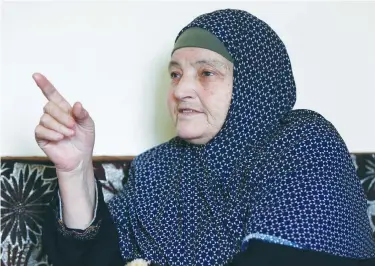  ?? (Muhammad Hamed/Reuters) ?? KAMLEH DAQAMSEH, mother of the Jordanian soldier convicted of killing seven Israeli schoolgirl­s in March 1997, speaks to the media at her home in the village of Ibdir yesterday after her son’s release.