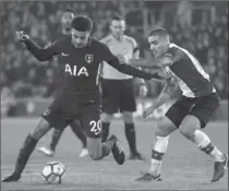  ??  ?? Tottenham’s Dele Alli, left, takes the ball past Southampto­n’s Oriol Romeu at the St Mary’s Stadium in Southampto­n, England.