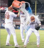  ?? Jae C. Hong
Associated Press ?? HUSTON STREET gets a dousing by Joe Smith, left, and Mike Trout after the Angels’ victory.