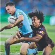  ??  ?? Felise Kaufusi tries to stop James Maloney in Origin II.