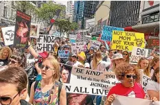  ??  ?? Animal rights activists head towards Lambton Quay where the A Very Welly Christmas festival was being held.